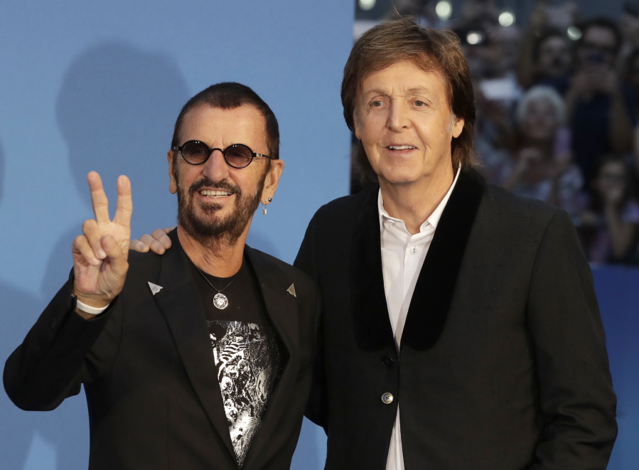 Musicians and former Beatles Paul McCartney, right, and Ringo Starr pose for photographers at the World premiere of the Beatles movie, Ron Howard&#039;s &quot;Eight Days a Week -- The Touring Years&quot; in London.
