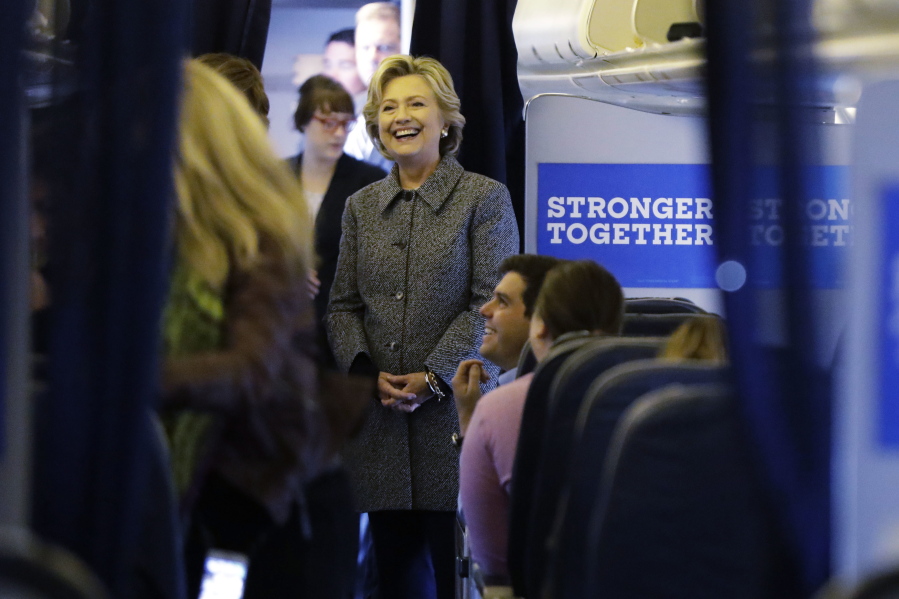 Democratic presidential candidate Hillary Clinton meets with her staff before taking off on her campaign plane at Westchester County Airport in White Plains, N.Y., on Thursday.