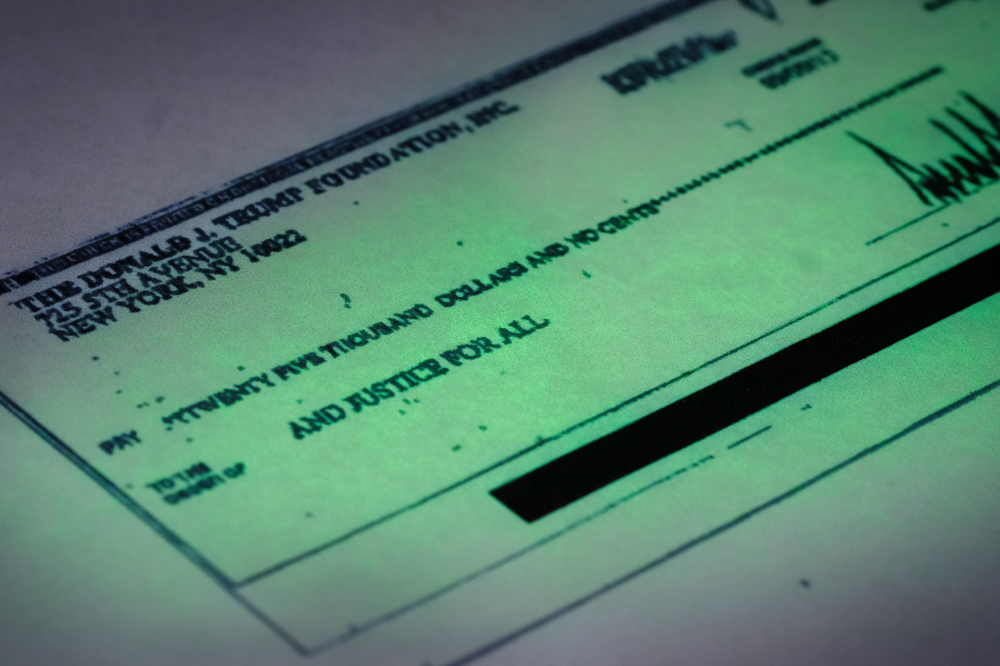 A copy of a check signed by Donald Trump shows a payment of $25,000 from the Donald J. Trump Foundation to And Justice For All,  a political action committee supporting Florida Attorney General Pam Bondi. (j.