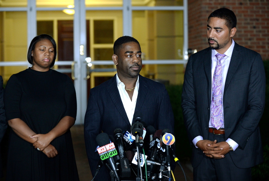 Rachel, left, and Ray Dotch, center, sister-in-law and brother-in-law to Keith Lamont Scott, give a news conference in Charlotte, N.C., on Saturday. At right is the family&#039;s attorney, Justin Bamberg. Scott was fatally shot by Charlotte-Mecklenburg Police Officer Brentley Vinson on Tuesday.