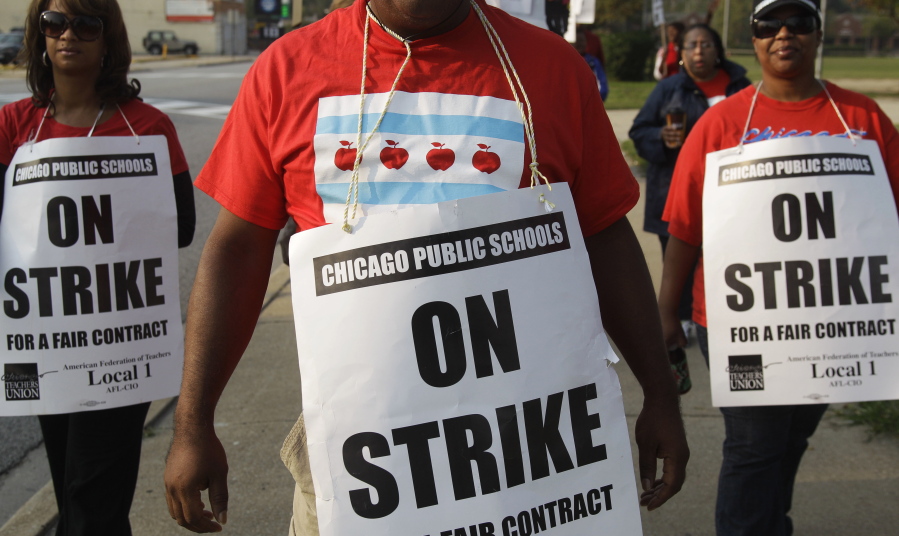 Teachers picket outside Morgan Park High School in Chicago. Teachers in the nation&#039;s third-largest public school district have overwhelmingly voted in support of a strike, though the earliest one could occur is mid-October. The Chicago Teachers Union said Monday that about 95 percent of its voting members favored strike authorization. (AP Photo/M.