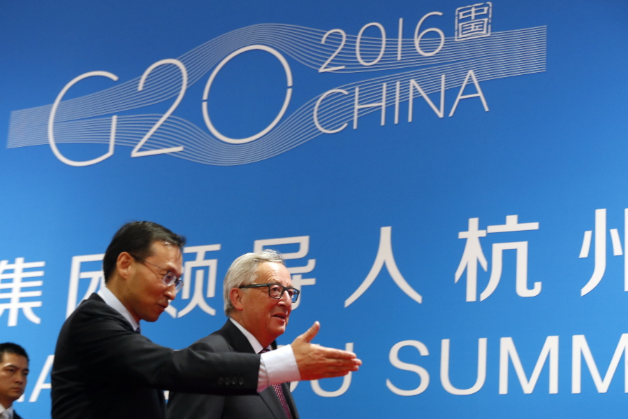 European Commission President Jean-Claude Juncker, right, is shown the way by a Chinese official as he arrives at the G-20 Summit in Hangzhou in eastern China&#039;s Zhejiang province, Sunday.