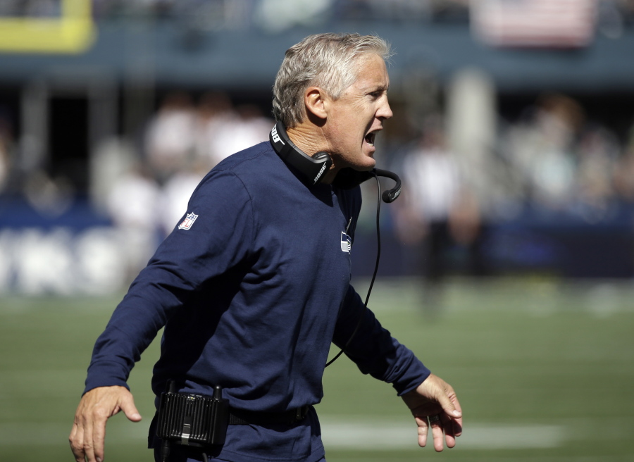 Seattle Seahawks head coach Pete Carroll calls to his team in the first half of an NFL football game against the Miami Dolphins, Sunday, Sept. 11, 2016, in Seattle.