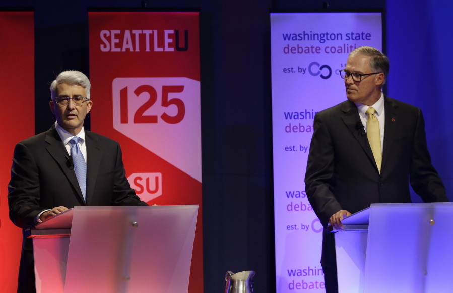 Washington Gov. Jay Inslee, right, a Democrat, and his Republican challenger, Bill Bryant, take part in a debate Monday in Seattle. (AP Photo/Ted S.