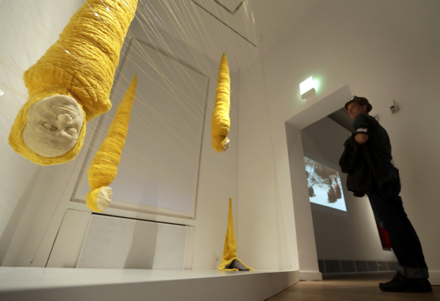 A man looks at the installation &quot;Crisalidas&quot; by Jorge Gil on Thursday at the &quot;Golem&quot; exhibition at the Jewish Museum in Berlin. The myth of artificial life, from homunculi and cyborgs to robots and androids, is the focus of an exhibition that runs until Jan. 29.