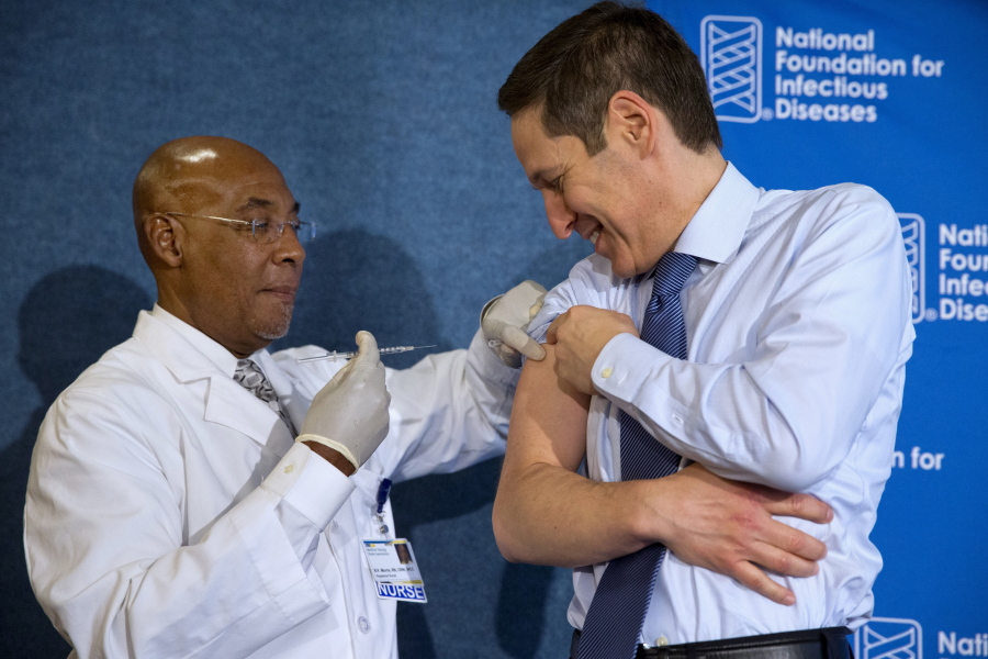 Nurse B.K. Morris, left, prepares to give the flu vaccine to Centers for Disease Control and Prevention Director Dr. Tom Frieden during an event in 2015 about the flu vaccine in Washington.
