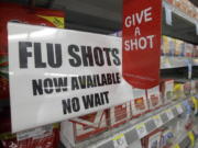 A sign tells customers that they can get a flu shot in a Walgreen store in Indianapolis.