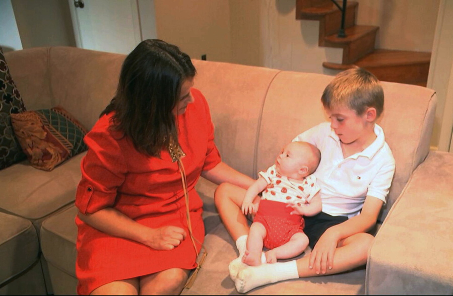 In this frame grab from video, taken Sept. 14, 2016, Sarah Gray with her son Callum, 6, and infant daughter Jocelyn in their Washington home. CallumC?Us identical twin Thomas died of a birth defect when he was just 6 days old, and the family donated ThomasC?U eyes, liver and umbilical cord blood for medical research. Now Gray has written a book about her unusual journey to find out if that donation really made a difference, revealing a side of science laymen seldom glimpse.