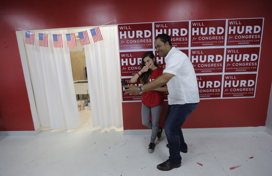 First-term Republican Rep. Will Hurd, right, of Texas, poses for a photo with a supporter at a campaign office, in San Antonio. Many House Republican incumbents worry that blowback from Republican presidential nominee Donald Trump&#039;s anti-Hispanic rhetoric and promises to build a towering wall the length of the U.S.-Mexico border could hurt their re-election chances, a problem especially acute for those in heavily Latino districts like that of Hurd, whose territory encompasses 820 miles of the U.S.-Mexico border.