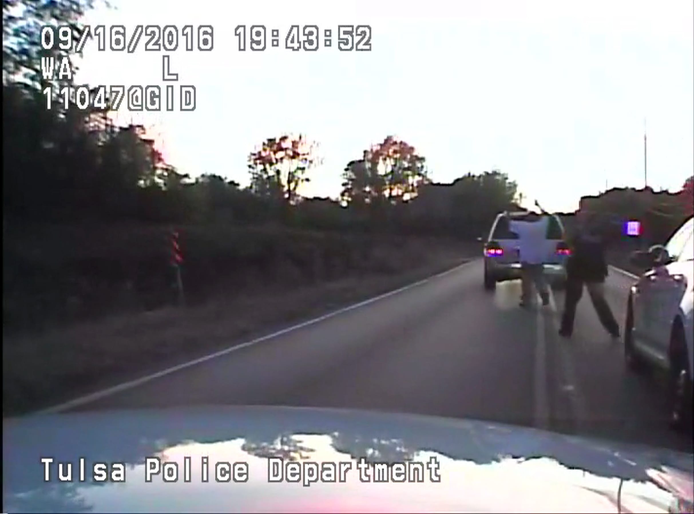 In this image made from a Friday, Sept. 16, 2016 police video, Terence Crutcher, left, is pursued by police officers as he walks to an SUV in Tulsa, Okla. Crutcher was fatally shot Friday after authorities say an officer stopped to investigate the stalled vehicle and Crutcher approached after officers arrived to assist. Crutcher had no weapon on him or in his SUV, Tulsa Police Chief Chuck Jordan said Monday, Sept. 19, 2016.