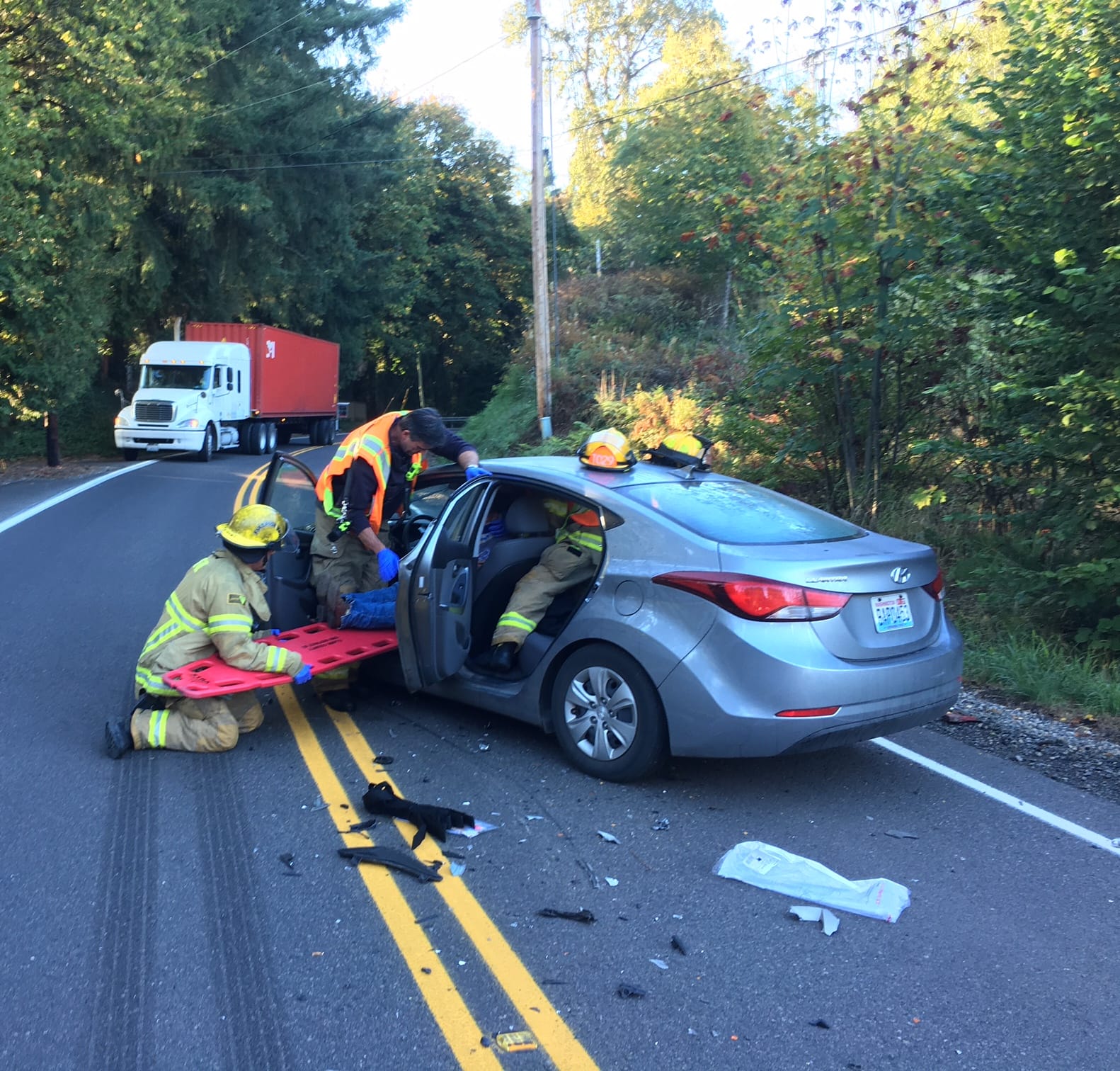 Firefighters extricated a 26-year-old woman after a head-on crash between a dump truck and a vehicle Wednesday morning. Timmen Road south of La Center is blocked in the area.