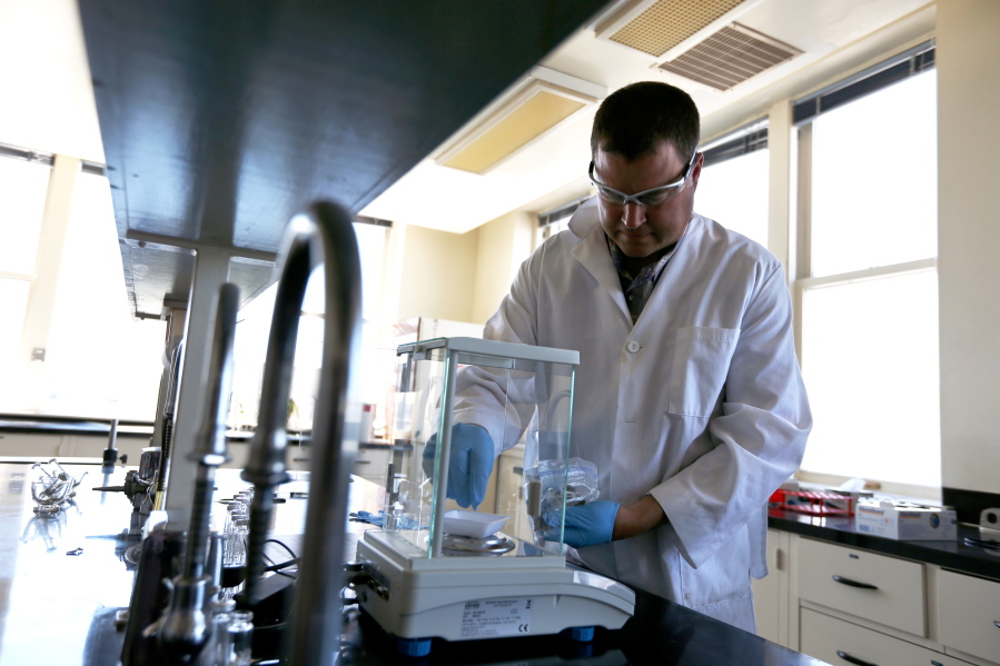 Randall Oliver, chief scientist for Analytical 360, scales out a sample of marijuana at their new cannabis analysis laboratory in Yakima in June 2014. Washington has agreed to begin more regular testing for banned pesticides in marijuana. The testing is expected to begin early next year and will examine marijuana where regulators have reason to suspect illegal pesticides have been used.