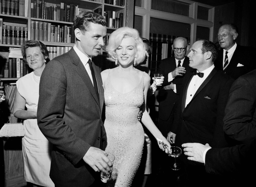 On May 19, 1962, actress Marilyn Monroe wears the iconic gown that she wore while singing &quot;Happy Birthday&quot; to President John F. Kennedy at Madison Square Garden, during a reception in New York City. Standing next to Monroe is Steve Smith, President Kennedy&#039;s brother-in-law. Julien&#039;s Auctions will offer Monroe&#039;s gown at a Nov. 17 auction in Los Angeles. (John F.