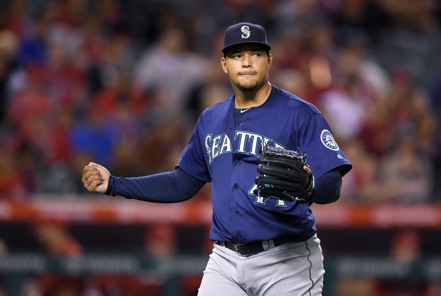 Seattle Mariners starting pitcher Taijuan Walker claps after finishing the fifth inning of a baseball game against the Los Angeles Angels, Tuesday, Sept. 13, 2016, in Anaheim, Calif. (AP Photo/Mark J.