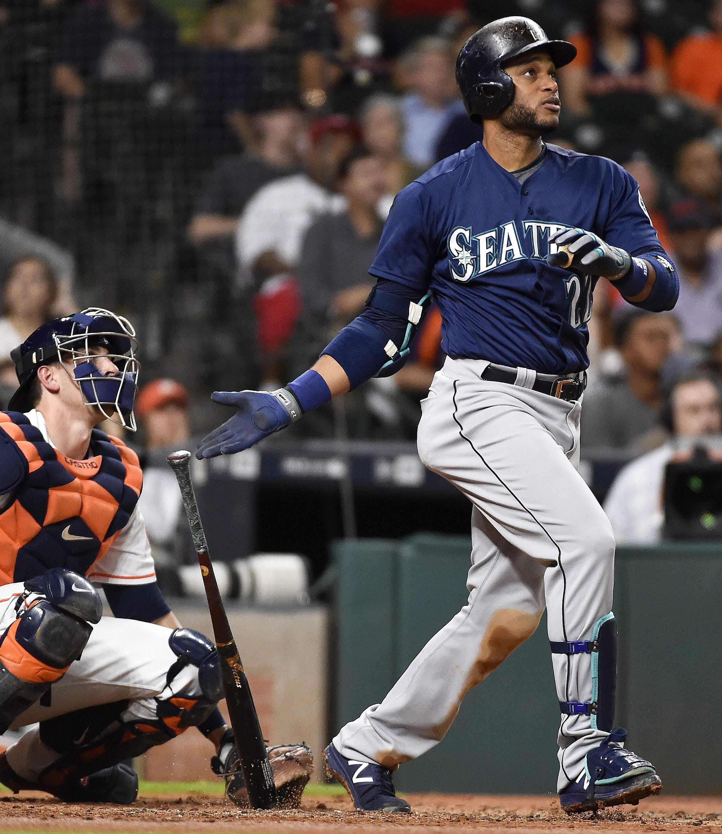 Seattle Mariners' Robinson Cano watches his solo home run off Houston Astros starting pitcher Collin McHugh during the third inning of a baseball game, Monday, Sept. 26, 2016, in Houston.