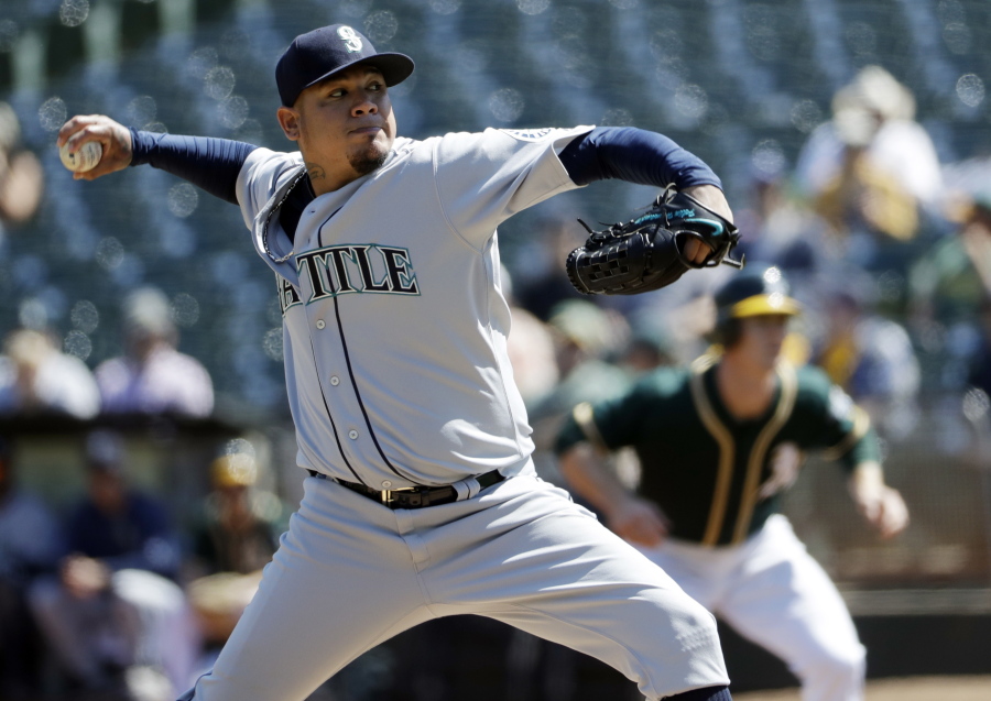 Seattle Mariners starting pitcher Felix Hernandez throws to the Oakland Athletics during the first inning of a baseball game, Saturday, Sept. 10, 2016, in Oakland, Calif.