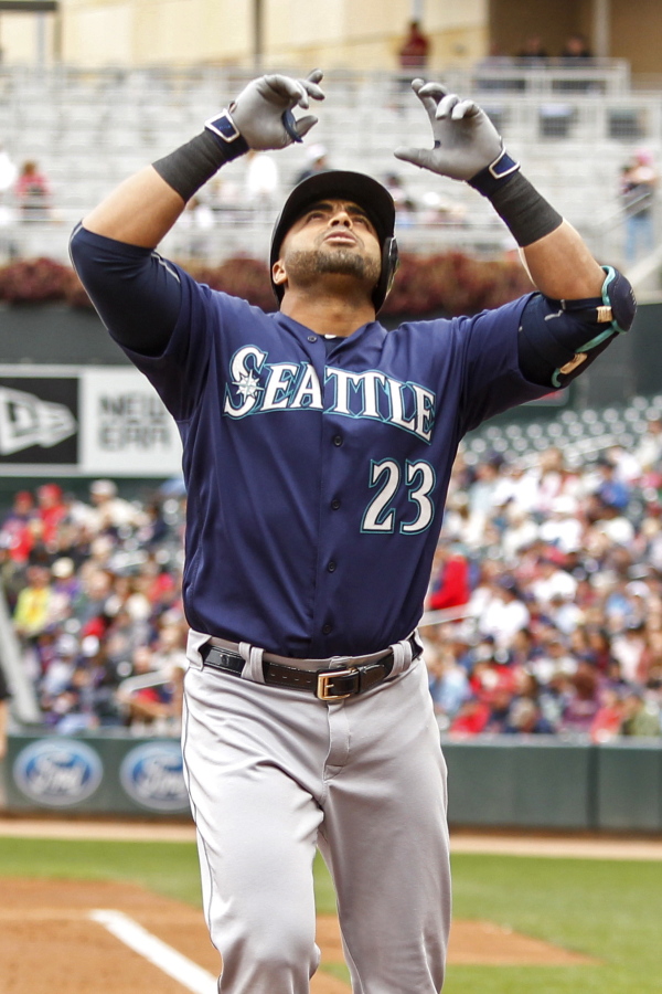 Seattle Mariners designated hitter Nelson Cruz celebrates his home run against the Minnesota Twins in the second inning of a baseball game Sunday, Sept. 25, 2016, in Minneapolis.