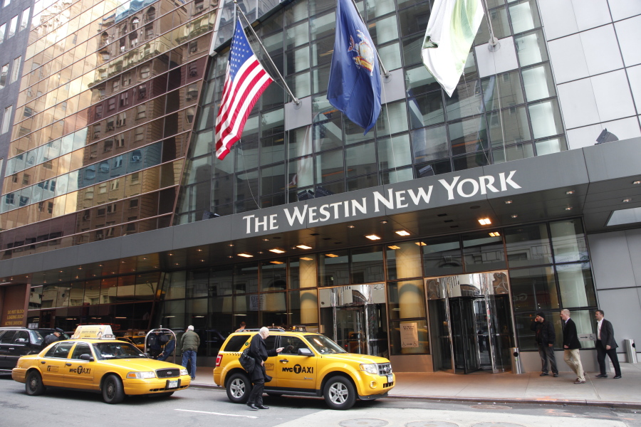 A man hails a taxi in front of the Westin New York hotel. Marriott International finalized its acquisition of Starwood Hotels &amp; Resorts Worldwide, bringing together its Marriott, Courtyard and Ritz-Carlton brands with Starwood&#039;s Sheraton, Westin, W and St. Regis properties.
