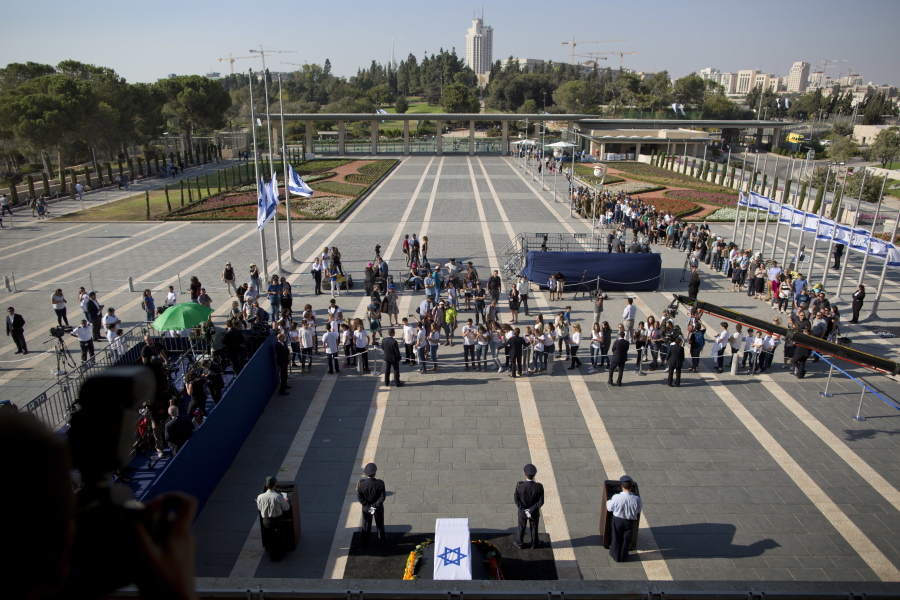 People line up to pay respect to former Israeli President Shimon Peres as they came to pay last respect at the Knesset plaza in Jerusalem on Thursday. Peres died early Wednesday from complications from a stroke. He was 93.