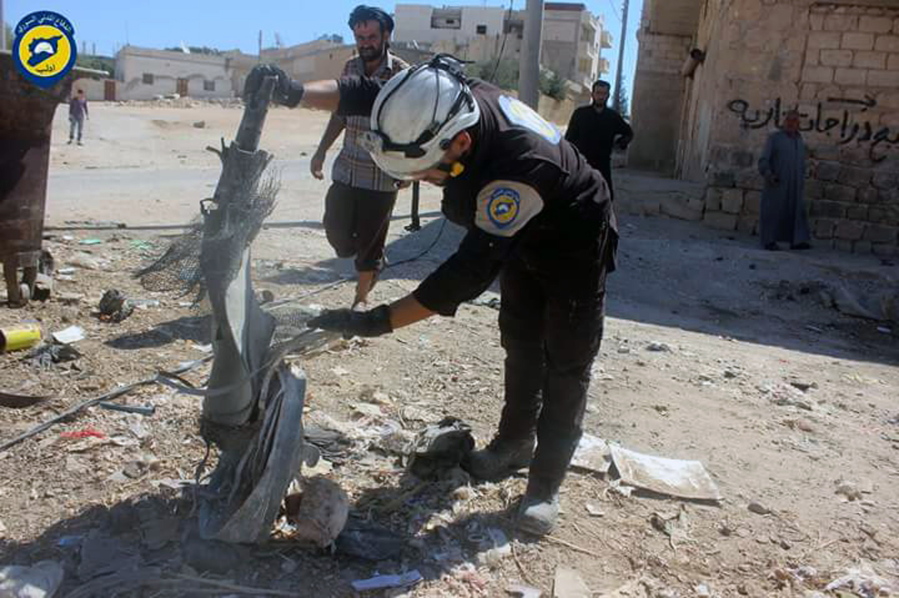 Members of Syrian Civil Defense group known as the White Helmets inspect the cluster bombs in the Khan Sheikhoun neighborhood of Idlib, Syria, on Thursday. The U.S. and Russia escalated their war of words over Syria on Thursday as government forces kept up their assault on Aleppo&#039;s rebel-held quarters and registered tenuous gains.
