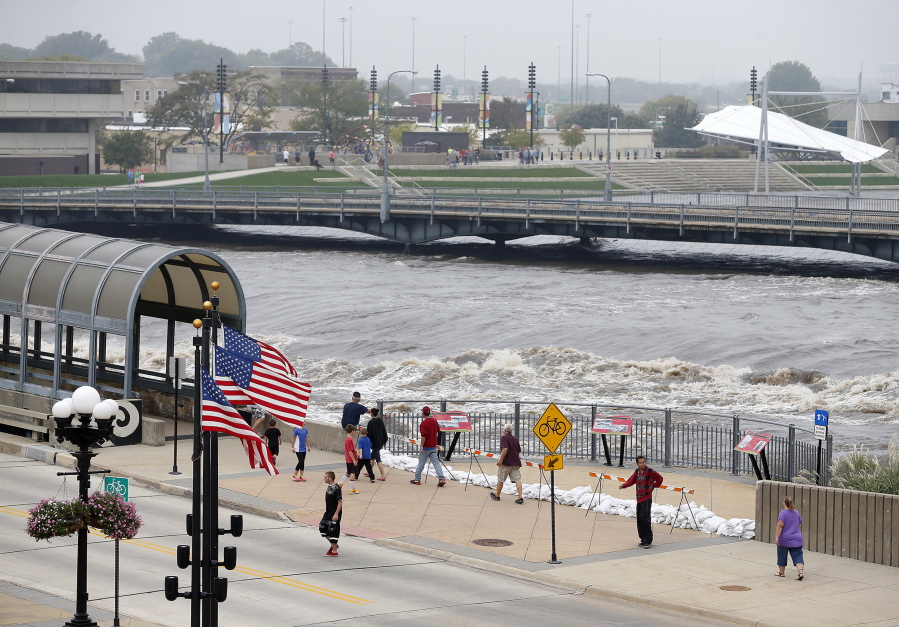 People view the flooding on the Cedar River in downtown Waterloo, Iowa, Saturday, Sept. 24, 2016.