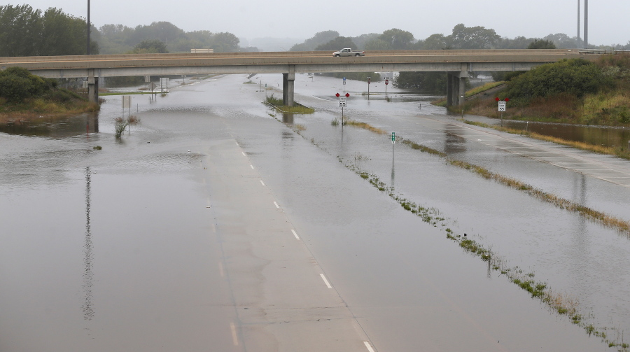 Floodwaters from the Cedar River cover Highway 57 on Saturday east of downtown Cedar Falls, Iowa.