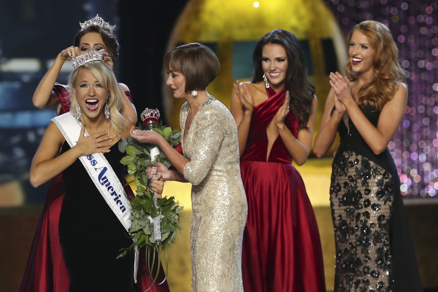 The outgoing Miss America, Betty Cantrell, back left, crowns the Miss America winner Miss Arkansas Savvy Shields, while Lynn Weidner, third right, assists, as Miss Maryland Hannah Brewer, second right, and Miss Texas 2016 Caroline Carothers, look on during the Miss America 2017 pageant Sunday in Atlantic City, N.J.