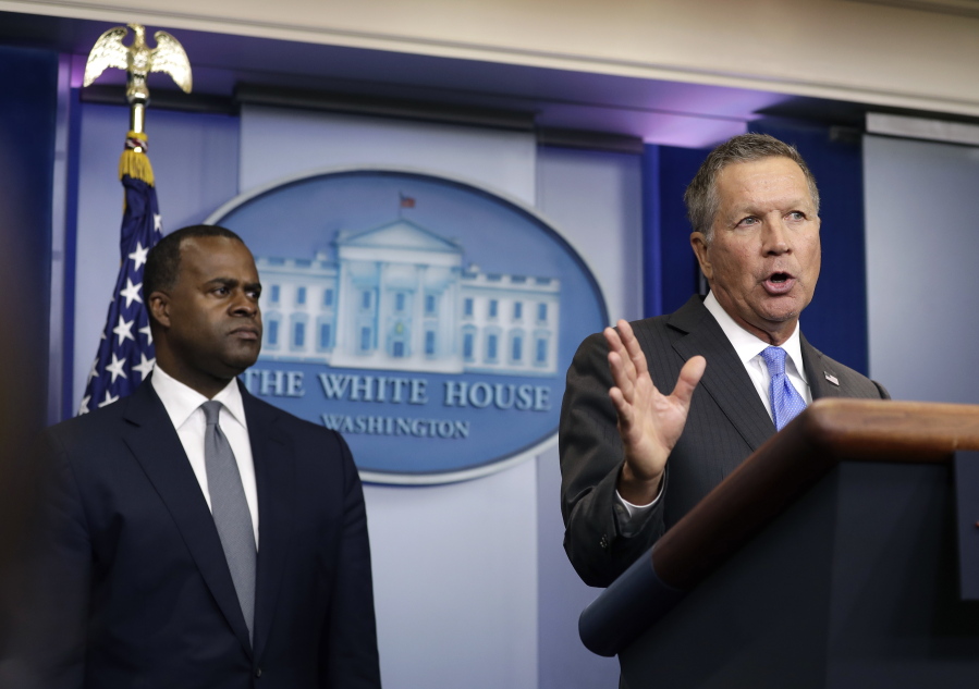 Atlanta Mayor Kasim Reed listens at left as Ohio Gov. John Kasich speaks Friday during the daily news briefing at the White House in Washington. Kasich and Reed discussed the presidential campaign and TPP, following a meeting with president in the Oval Office.