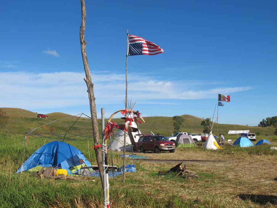 An American flag flies upside down in protest at an encampment near North Dakota&#039;s Standing Rock Sioux reservation on Friday, Sept. 9, 2016. The Standing Rock Sioux tribe&#039;s attempt to halt construction of an oil pipeline near its North Dakota reservation failed in federal court Friday, but three government agencies asked the pipeline company to &quot;voluntarily pause&quot; work on a segment that tribal officials say holds sacred artifacts.