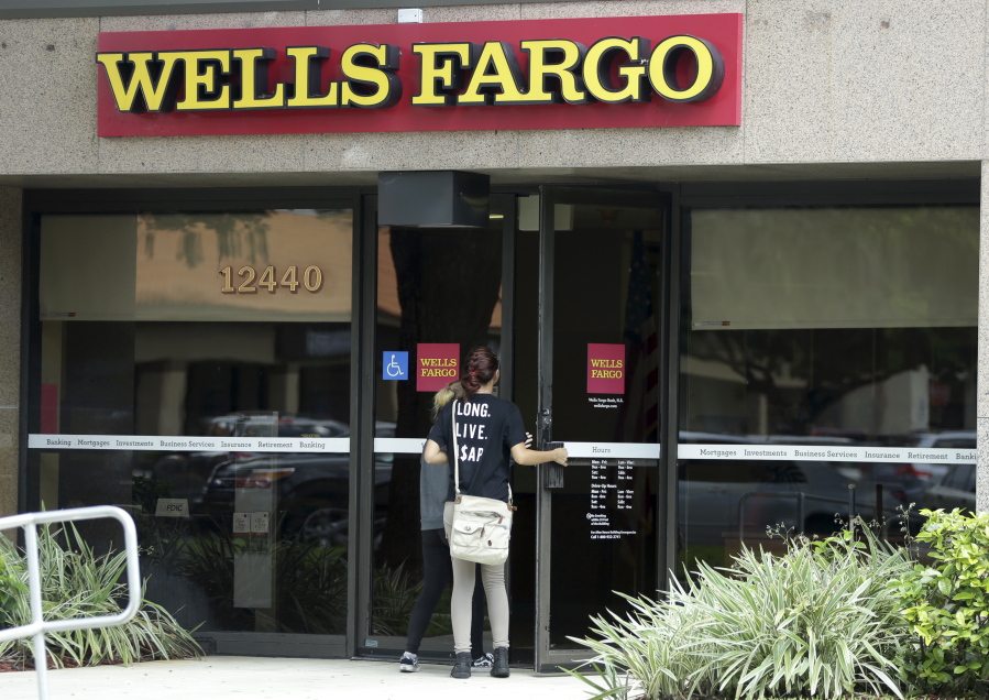 Customers walk into a Wells Fargo bank in Pembroke Pines, Fla. Experts say Wells Fargo customers concerned about whether their accounts have been tinkered with shouldn&#039;t wait for word from the bank.