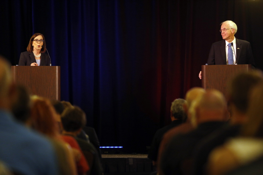 Oregon Gov. Kate Brown, left, and Republican challenger Bud Pierce participate in the first governor debate at the Riverhouse in Bend, Ore., on Saturday, Sept. 24, 2016.
