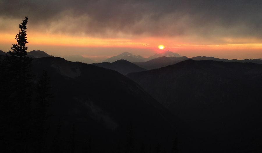 The sun sets behind the mountains in August, as seen from the Pacific Crest Trail north of Harts Pass. Loerch hiked part of the Pacific Crest Trail alone.