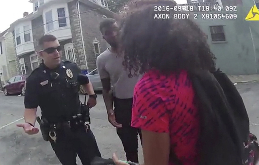 In this Sunday,  video frame grab from a body camera released by the Hagerstown (Md.) police, an officer speaks with a 15-year-old girl in Hagerstown, Md. An officer pepper-sprayed the 15-year-old girl in a police cruiser when she refused to put her feet inside. A police spokesman says several officers involved in the pepper-spray arrest of a 15-year-old girl remain on duty while the department investigates.