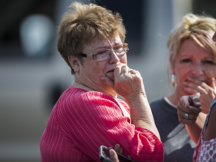 A woman reacts following a shooting at Townville Elementary in Townville, S.C., on Wednesday. A teenager killed his father at his home Wednesday before going to the nearby elementary school and opening fire with a handgun, wounding two students and a teacher, authorities said.