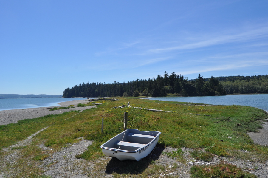 This Aug. 12, 2016 photo, a boat rests on the Wolfe Property near Port Ludlow, Wash.  The unofficial state park known as the Wolfe Property near Port Ludlow, Wash. sits just north of the Hood Canal bridge on the Olympic Peninsula. The property features a warm water bay, large lagoon and nearly 200 forested acres.