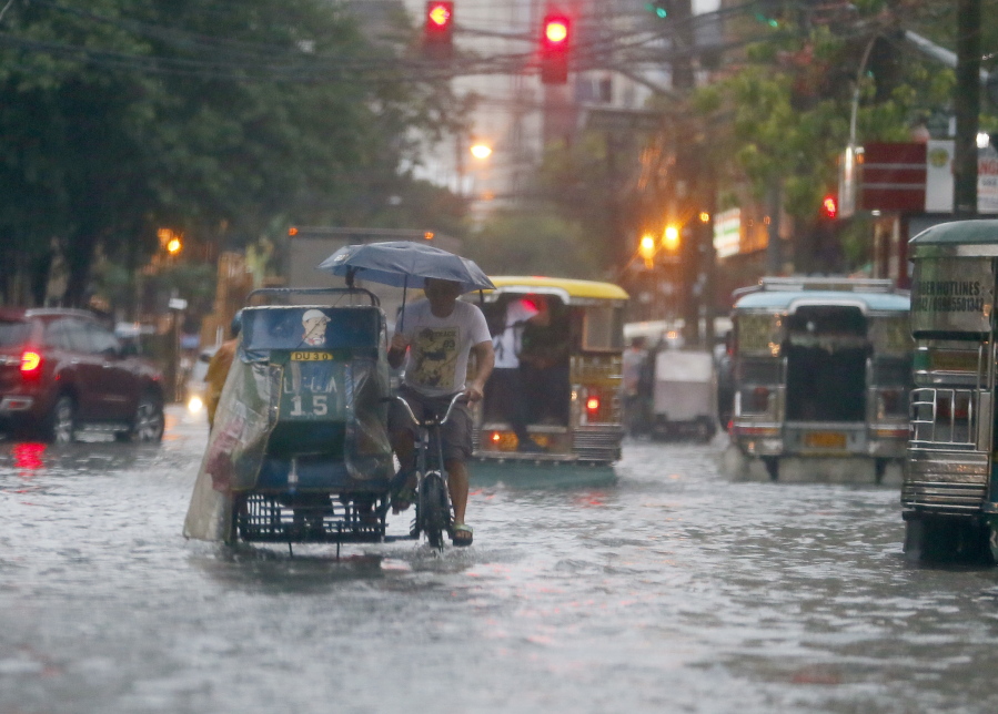 Commuters and motorists try to navigate wet roads in August as heavy monsoon rains inundate low-lying areas in Manila, Philippines. Typhoons that slam into land in the northwestern Pacific -- especially the biggest tropical cyclones of the bunch -- have gotten considerably stronger since the 1970s, a new study concluded.