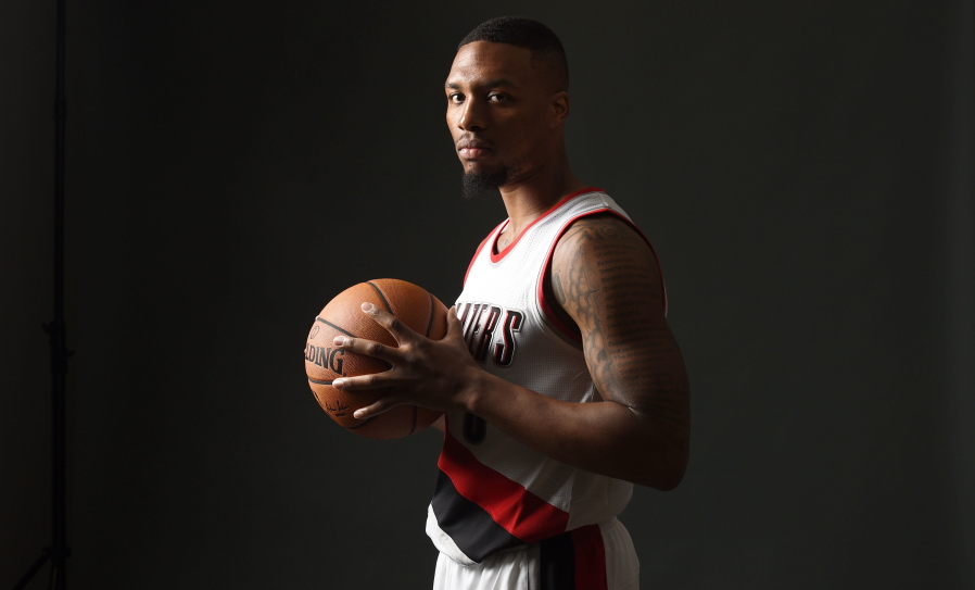 Portland Trail Blazers guard Damian Lillard (0) poses for a photograph during NBA basketball media day in Portland, Ore., Monday, Sept. 26, 2016.