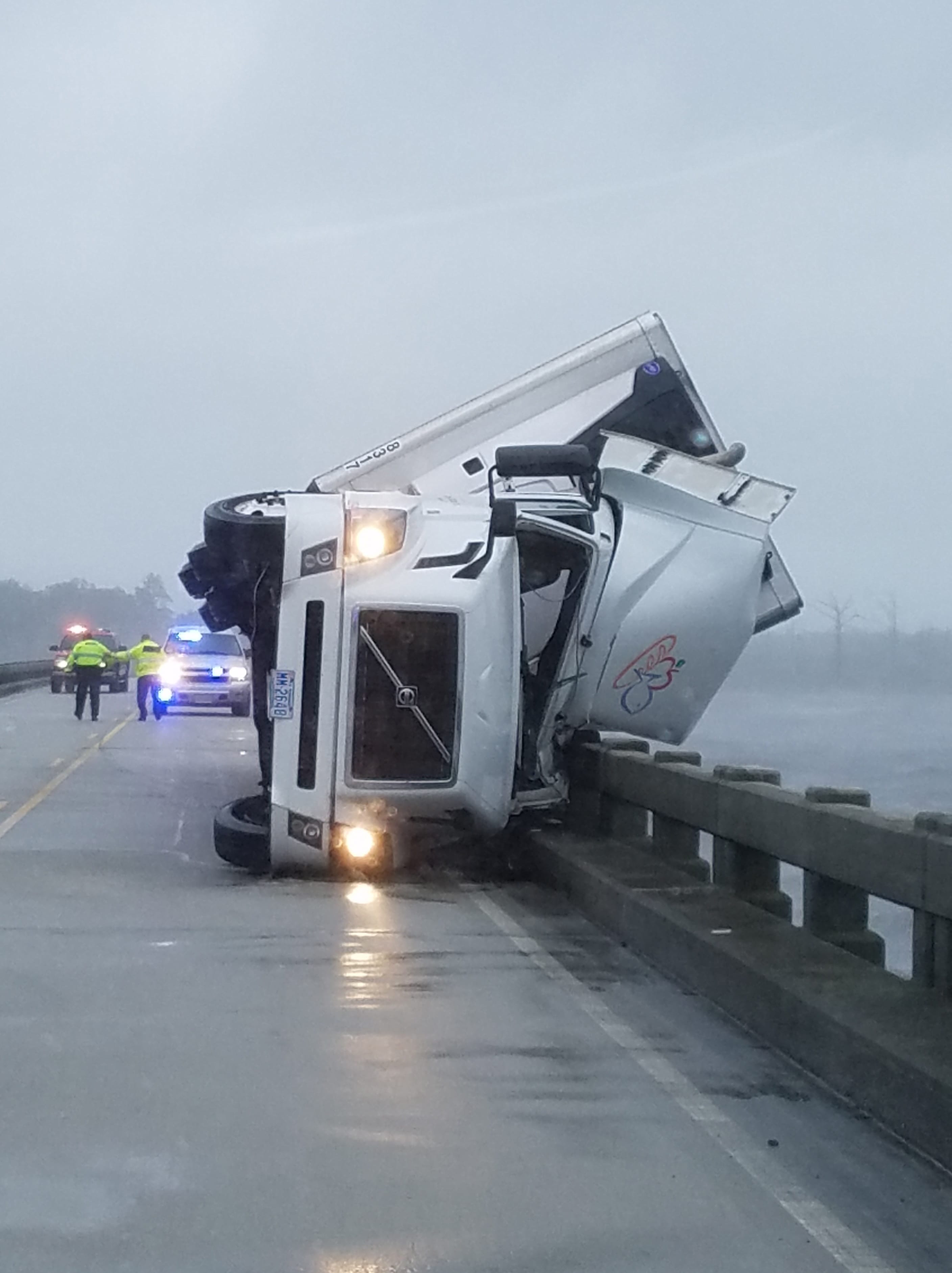 In this photo provided by Tyrrell County SheriffÄôs office shows a tipped over 18-wheeler in Columbia, N.C., on Saturday, Sept. 3, 2016.  Tyrrell County Sheriff Darryl Liverman said that high winds tipped over the 18-wheeler, killing its driver and shutting down the U.S. 64 bridge during Tropical Storm Hermine.