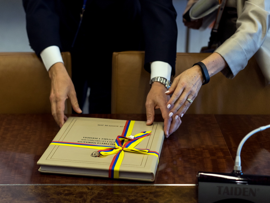A book representing a peace agreement forged in Colombia is set on a conference table, shortly thereafter given to United Nations Secretary-General Ban Ki-moon from President Juan Manuel Santos of Colombia during a meeting at the United Nations headquarters Monday. Santos recently reached a comprehensive cease-fire agreement with FARC rebels in Colombia.