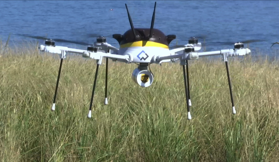 A test drone making a UPS delivery lands on Children&#039;s Island in Marblehead, Mass. UPS partnered with robot-maker CyPhy Works to fly the drone on a programmed route for 3 miles over the Atlantic Ocean to make the delivery.