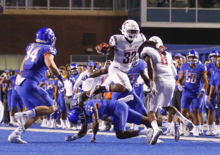 Washington State running back James Williams (32) leaps over Boise State cornerback Tyler Horton (14) during the first half of an NCAA college football game in Boise, Idaho, Saturday, Sept. 10, 2016.