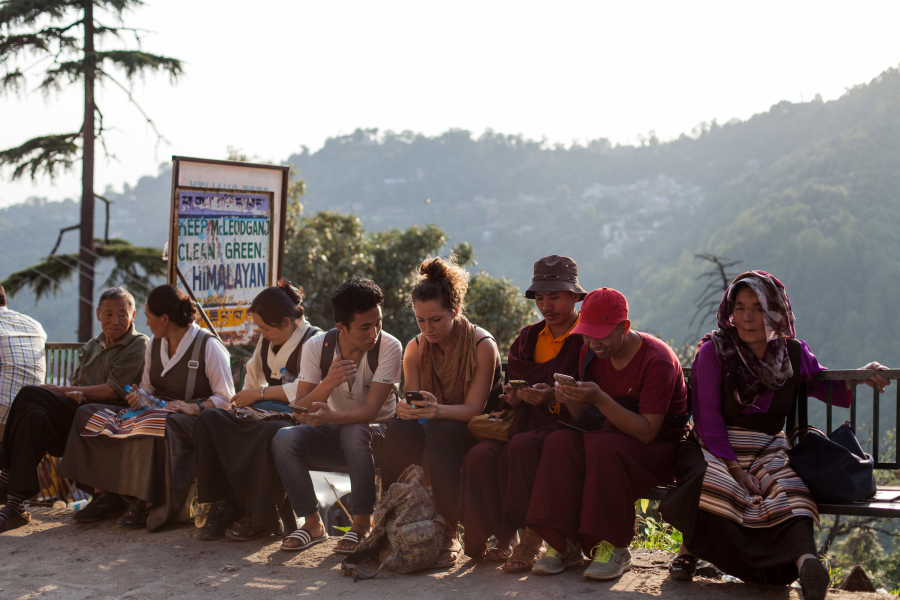 People use smartphones in Dharamsala, India, on June 9.