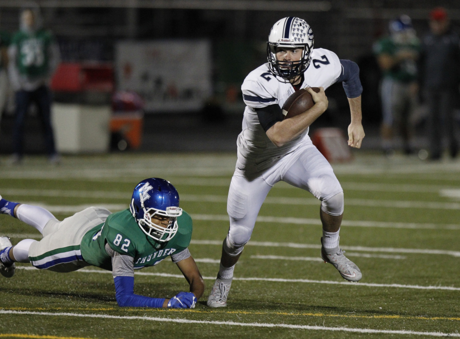 Skyview quarterback Brody Barnum (2) runs for a touchdown against Mountain View defender Eric Campbell (82) at 4A GSHL football league tiebreaker between Skyview, Battle Ground, Mountain View.