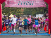 Participants in the Girlfriends Run for a Cure half marathon start their footrace in 2014 in downtown Vancouver.