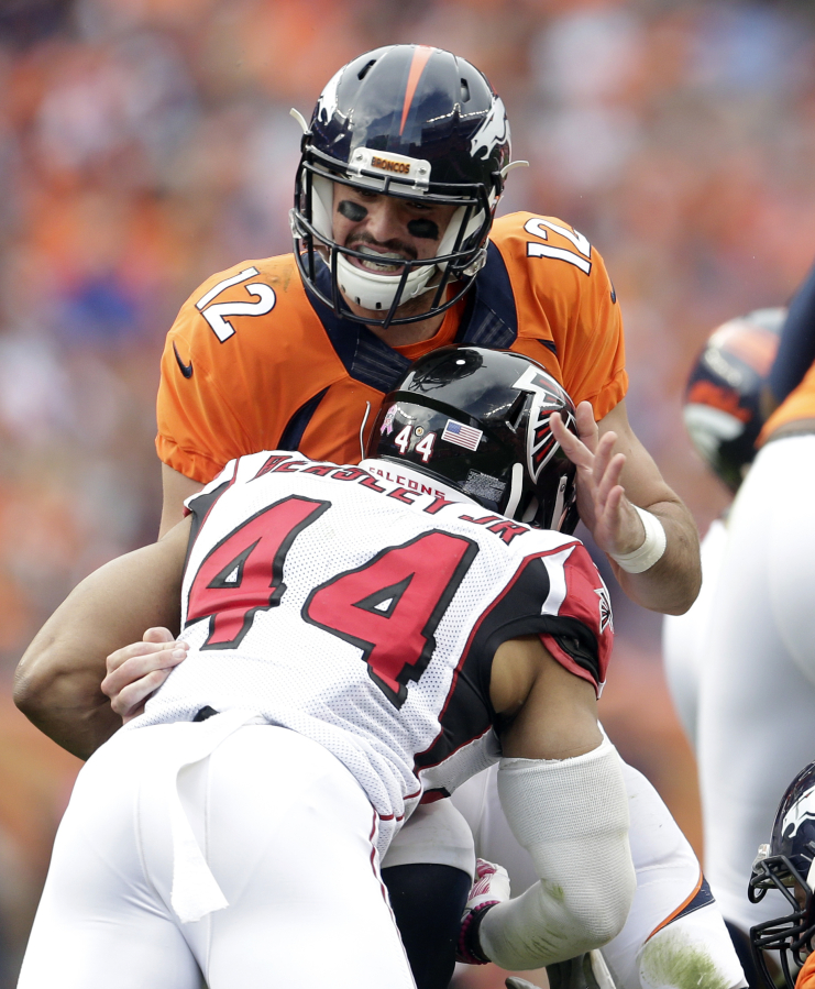 Denver Broncos quarterback Paxton Lynch (12) is sacked by Atlanta Falcons outside linebacker Vic Beasley (44) during the second half of an NFL football game, Sunday, Oct. 9, 2016, in Denver.