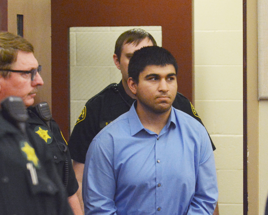 Arcan Cetin is escorted into Skagit County District Court by Skagit County sheriff&#039;s deputies on Sept. 26. Cetin is accused in the Sept. 23 Cascade Mall shooting where five people were killed.