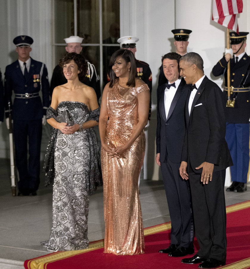President Barack Obama and first lady Michelle Obama pose for pictures with Italian Prime Minister Matteo Renzi and his wife, Agnese Landini, left, upon their arrival for a state dinner Tuesday at the White House on Oct. 18.