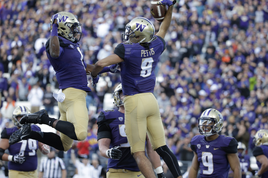 Washington&#039;s John Ross, left, and Dante Pettis leap to celebrate Pettis&#039; touchdown against Oregon State in the first half of an NCAA college football game Saturday, Oct. 22, 2016, in Seattle.
