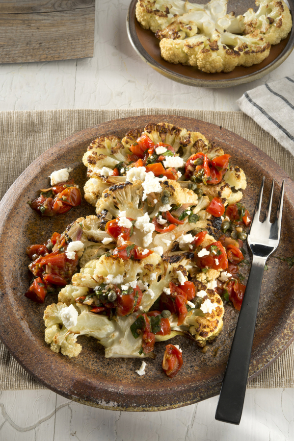 Roasted cauliflower steaks with tomatoes and feta.