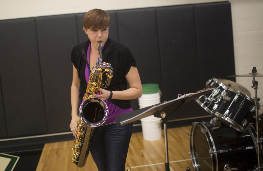 Bryana Steck plays bari sax while leading the pep band Thursday in the Woodland gymnasium during the Beavers&#039; volleyball win over Columbia River.